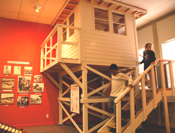 Children exploring the 1940 's "secret city" guard tower and photographs and memorablia from the World War II era.
