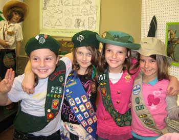 These girls are trying on hats and sashes from different eras. Visiting groups are welcome to schedule a time to try on vintage uniforms from our extensive collection.